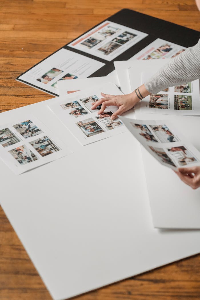 Home Creative arrangement of printed photos on a wooden floor, showcasing a photography project.